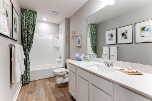 Full bathroom on the main level. *Photos are of a previously staged model*