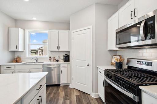 This home showcase a stunning backsplash complemented by elegant hardware. *Photos are of a previously staged model*