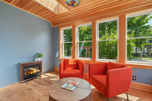 The sunroom is inviting, featuring a heated floor creating comfortable year round space to relax and unwind.
