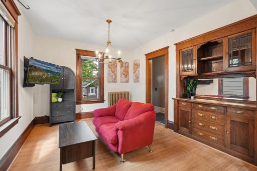 Beautiful custom built in cabinetry and storage seamlessly intergrated into the walls and archarchitecture. This room creates functionality for dining or custom-fitted furnishing.