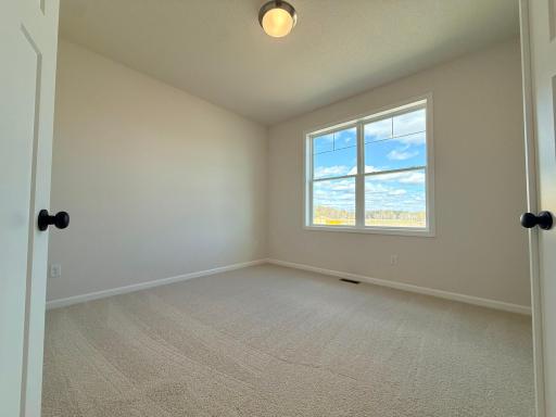 The front bedroom features double doors to add flexibility to the space