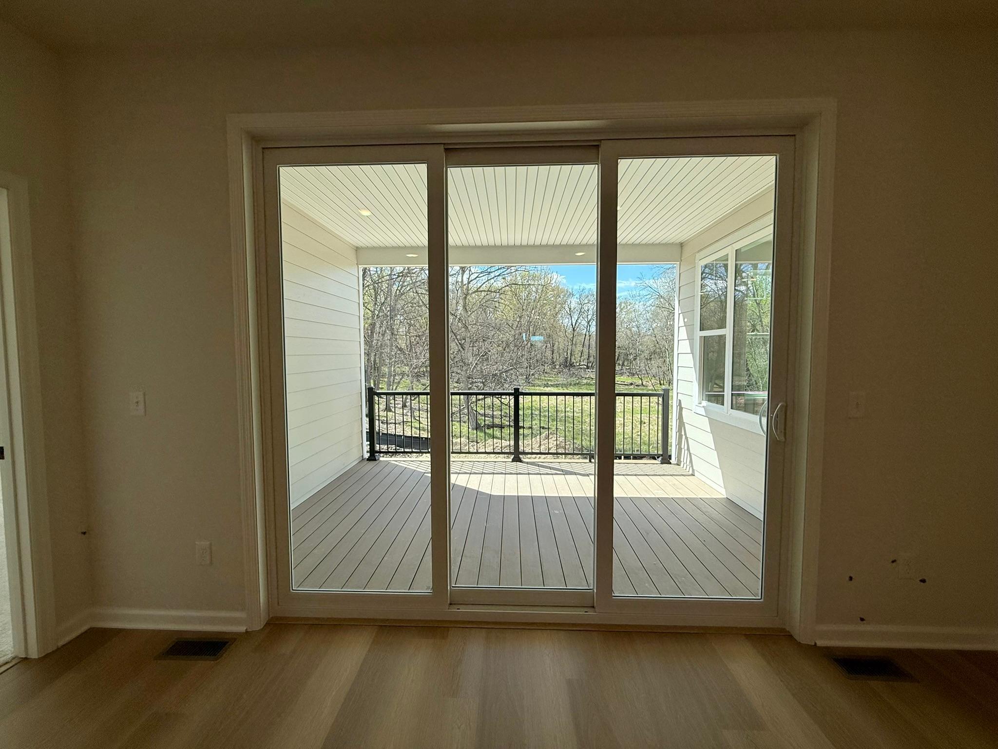 The upgraded patio door takes advantage of the private wooded views