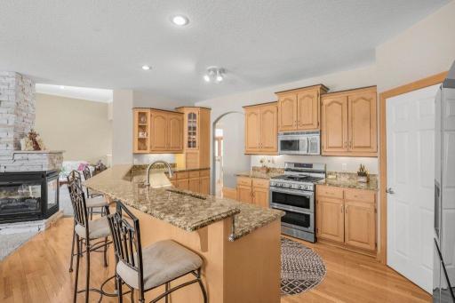 Kitchen has a huge breakfast bar, granite countertops, high-end stainless appliances, and corner panty.