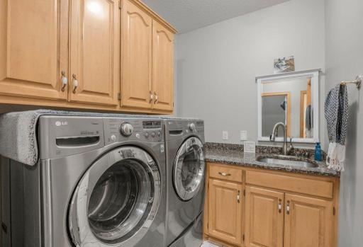 1 of 2 laundry rooms! Tons of storage and a sink!