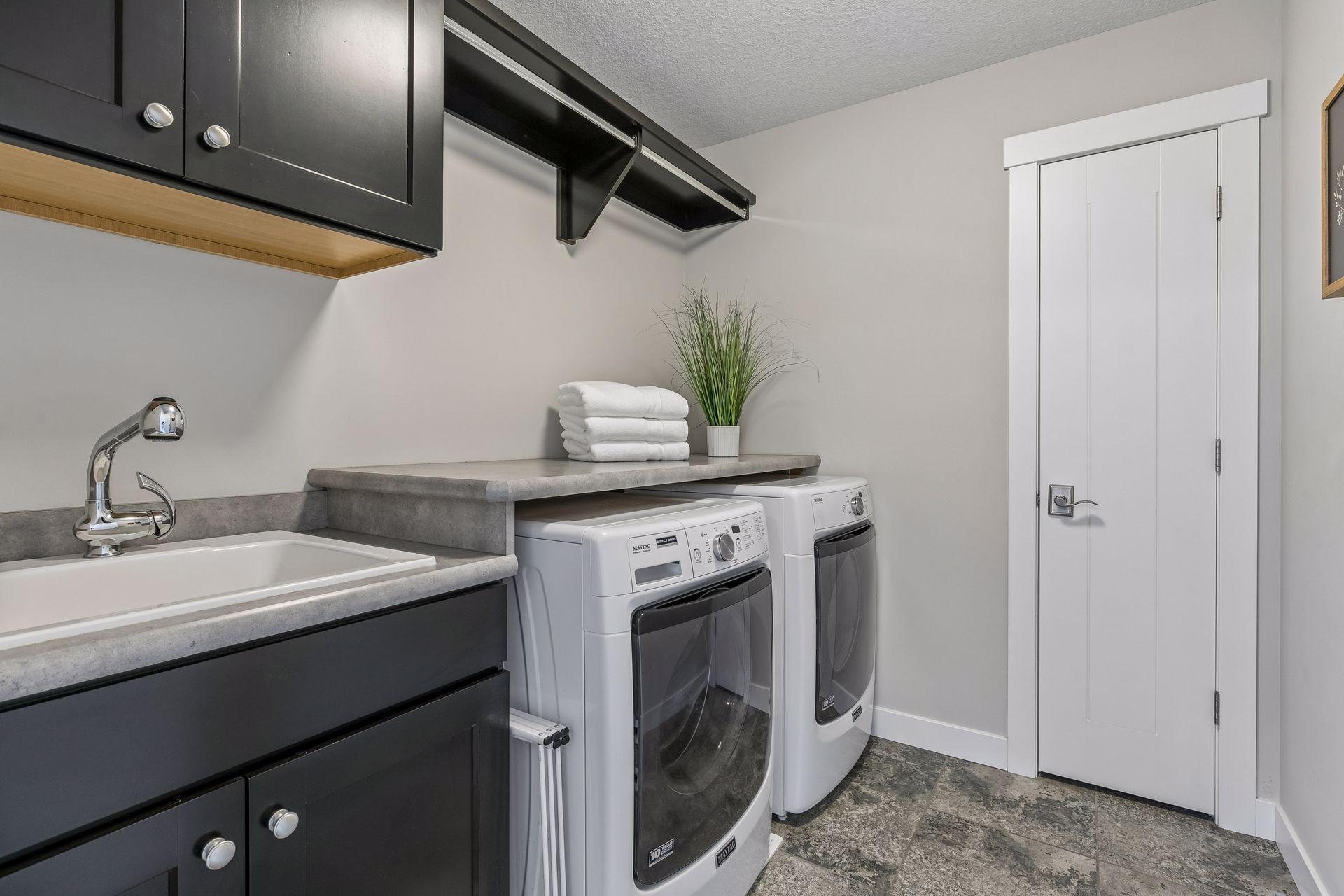 The laundry room with utility sink & linen closet rounds out the upper level perfectly!