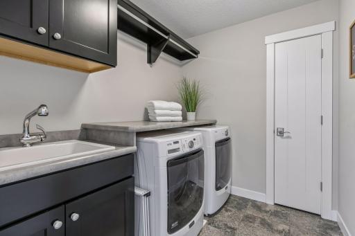 The laundry room with utility sink & linen closet rounds out the upper level perfectly!
