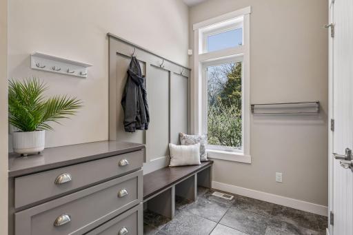 A large mudroom with built-in lockers, a drop zone & closet making a fantastic transition area!