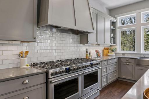 Not one but two ovens & gas ranges with custom wood hood - let the master chef begin!
