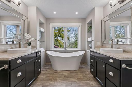 A spa-like ensuite bathroom with dual vanities, soaker tub, shower & even toe kick nightlights!