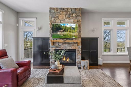 Handsome, functional built-ins flank the stone fireplace.
