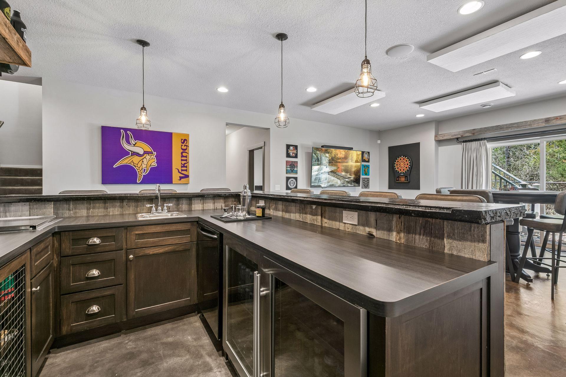 This bar includes a full size dishwasher, double-sized beverage fridge, a large ice bin & mini sink.