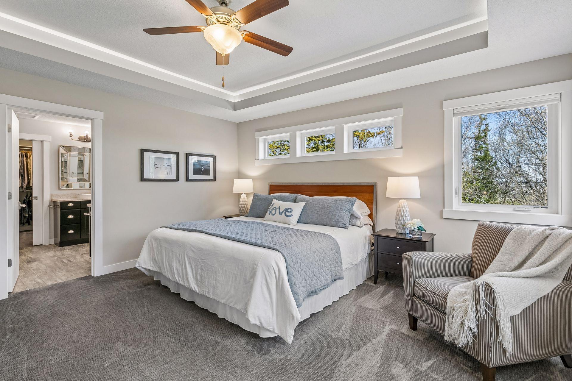 Both peaceful & beautiful primary suite with added details such as the tray ceiling & adjustable Hue lighting.