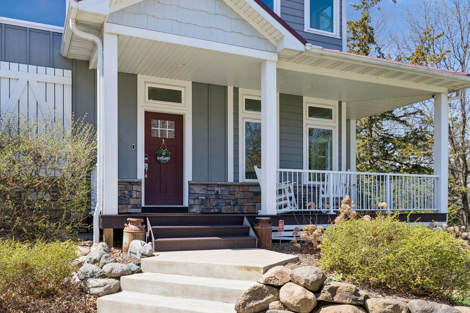 Traditional & warm front entrance that includes a wraparound Trex deck.