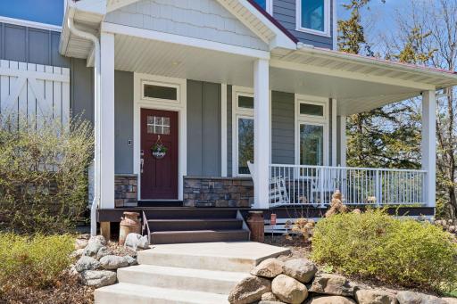 Traditional & warm front entrance that includes a wraparound Trex deck.