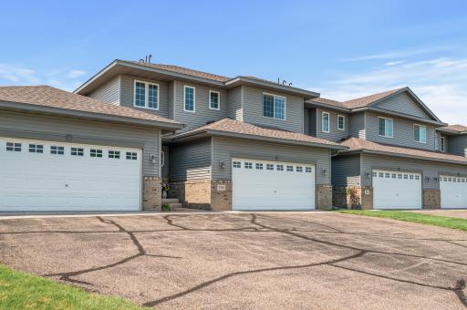 Two story townhome in Big Lake with attached 2 car garage, low maintenance exterior, and welcoming private entry at 705 Independence Drive.