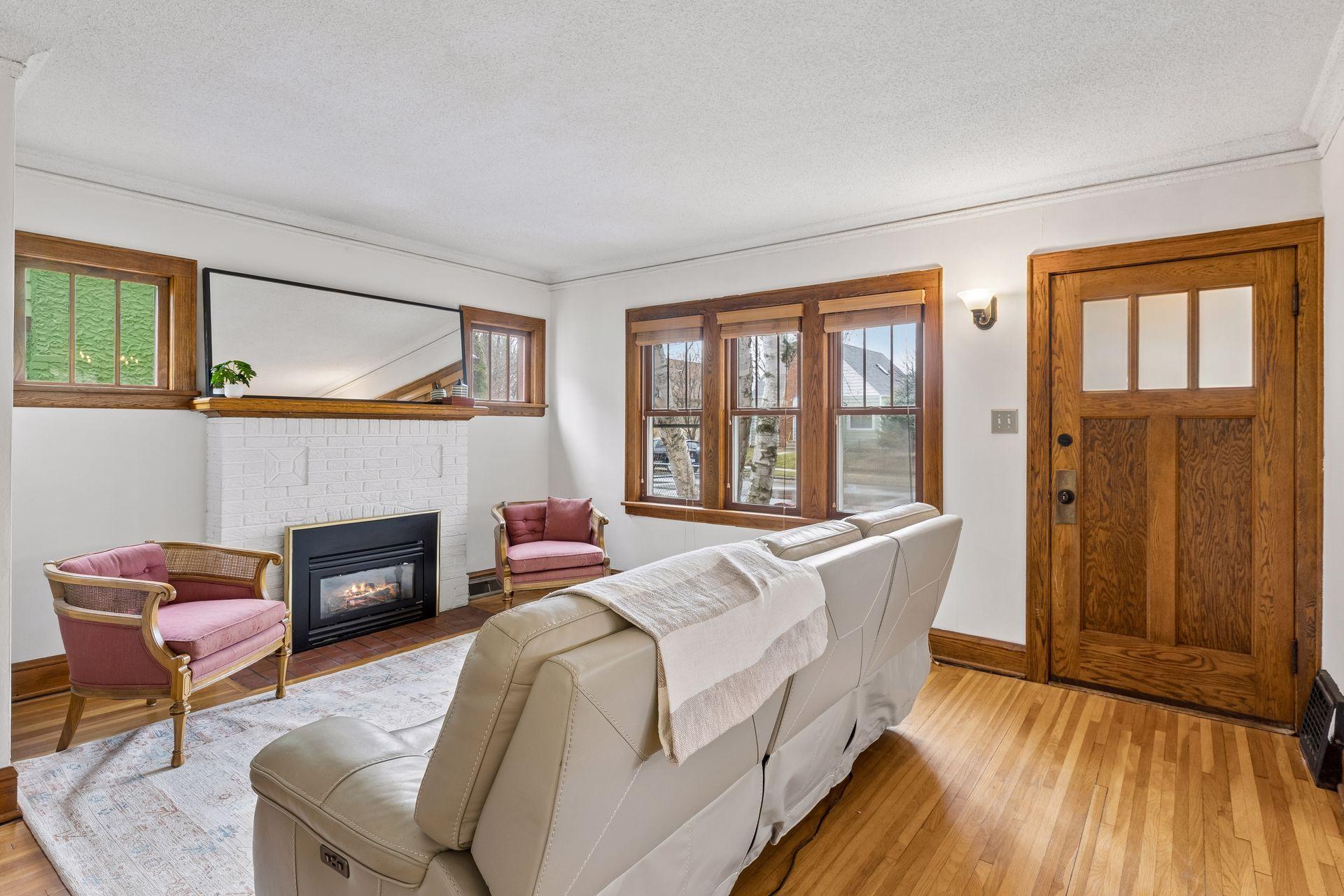 Here is the spacious living room with its fireplace and beautiful windows.