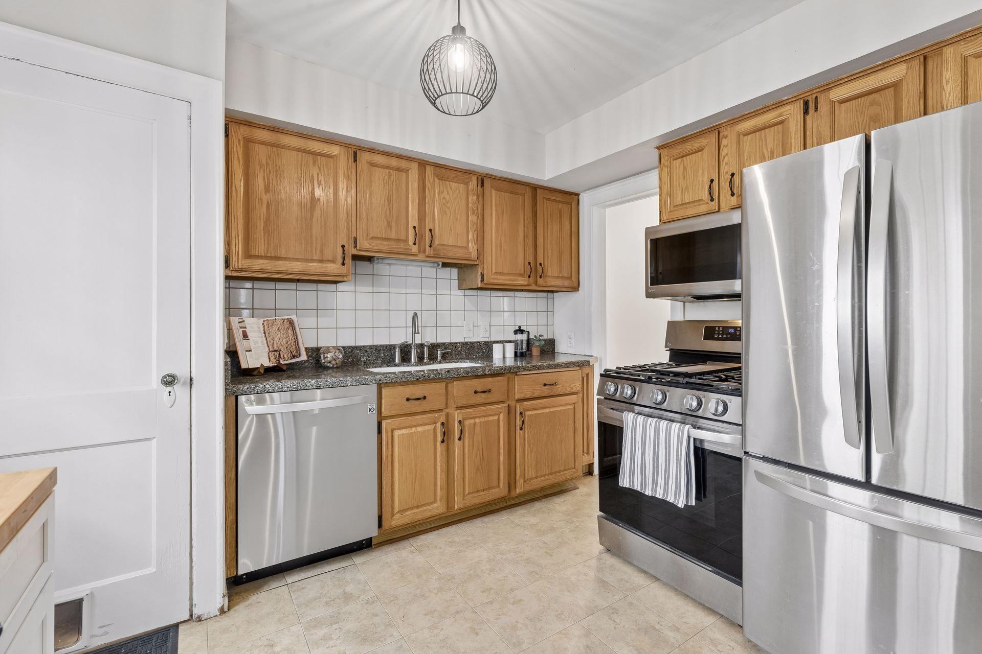 Check out this beautiful kitchen with stone counters and stainless appliances.