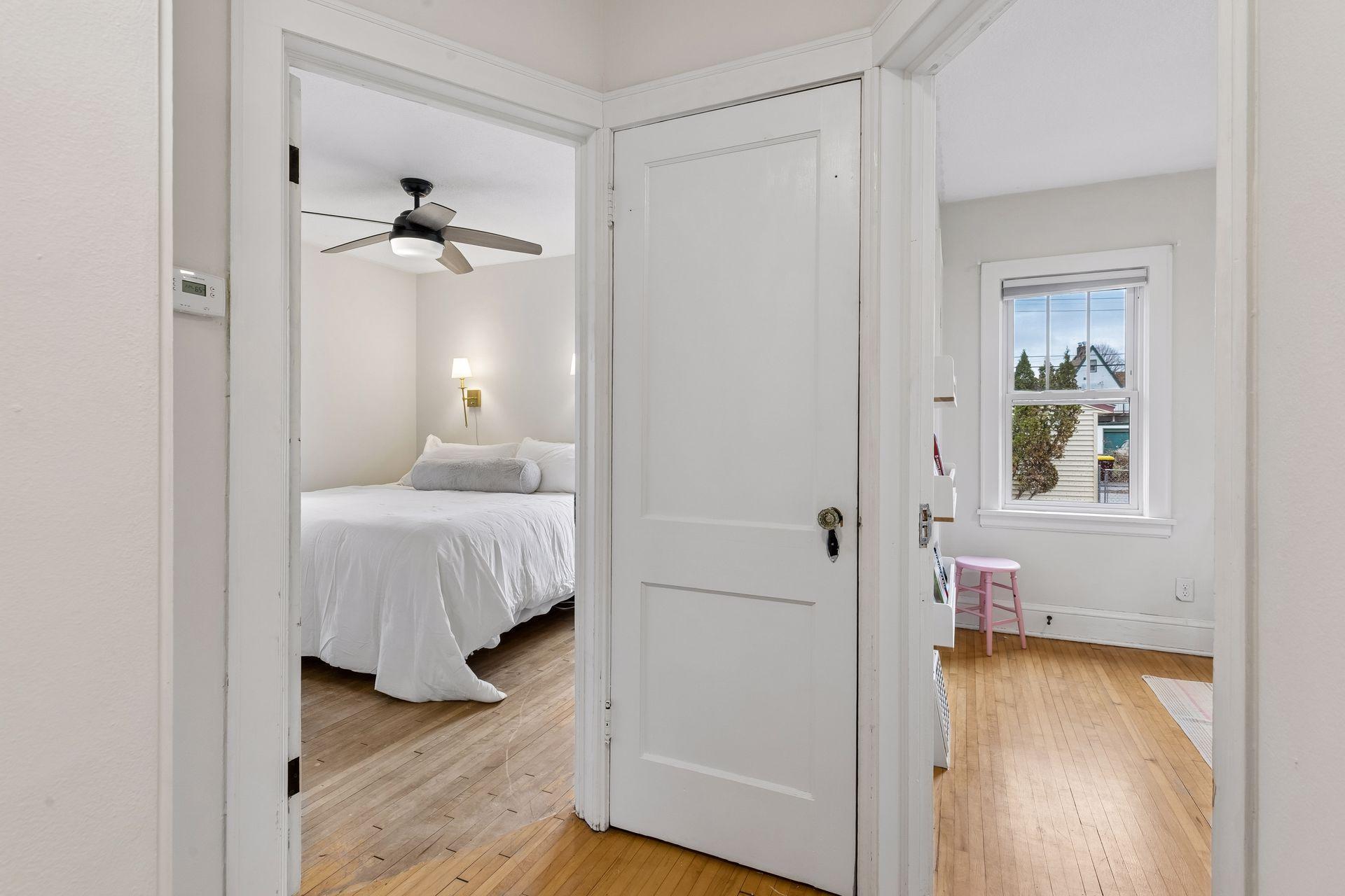 This shot from the hallway shows a peek into each bedroom, with the door to the upstairs in the middle.