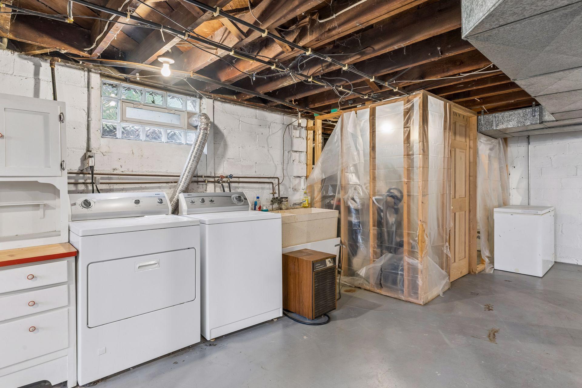 This view of the basement shows the laundry area and the mechanical room.