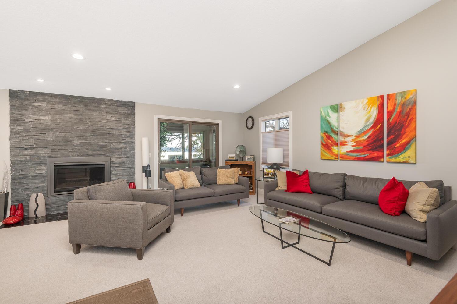 Relax with a view of the lake! Enjoy the warm gas fireplace finished in stone on a cool winter day.