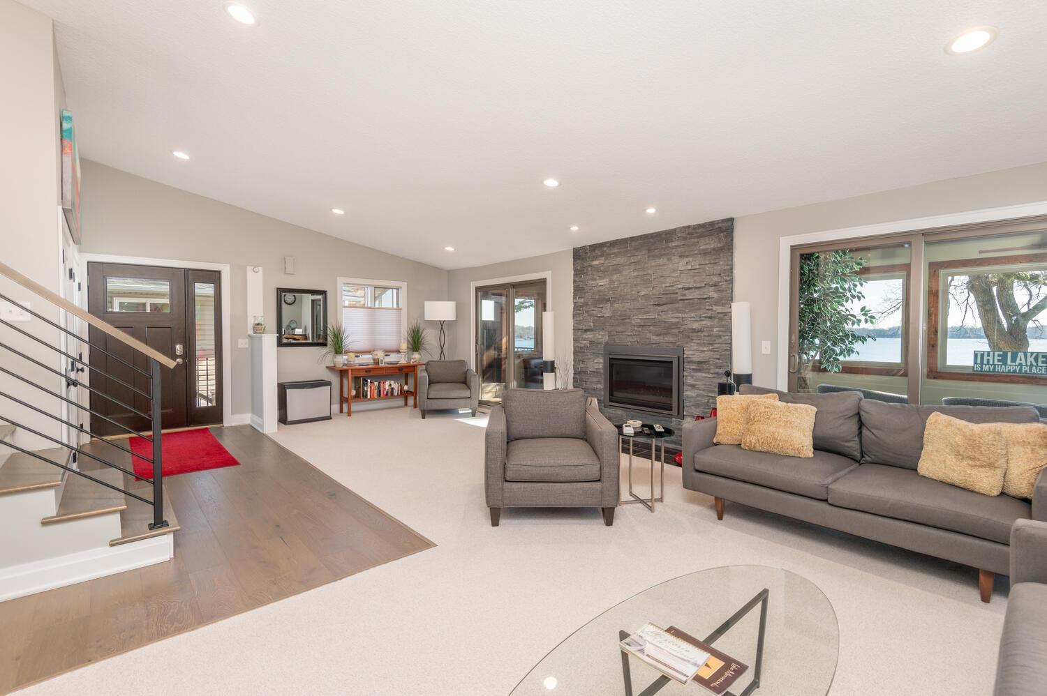 This living room area has Andersen sliding doors that step out to a 3 season porch that runs the width of the home.