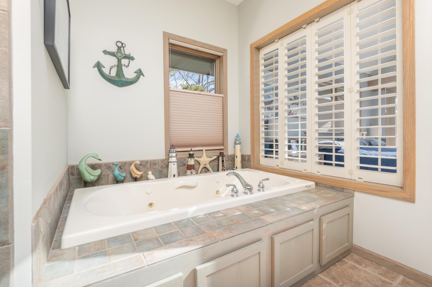The whirlpool bath can see the lake through the plantation shutters. There is also a very roomy walk in shower.