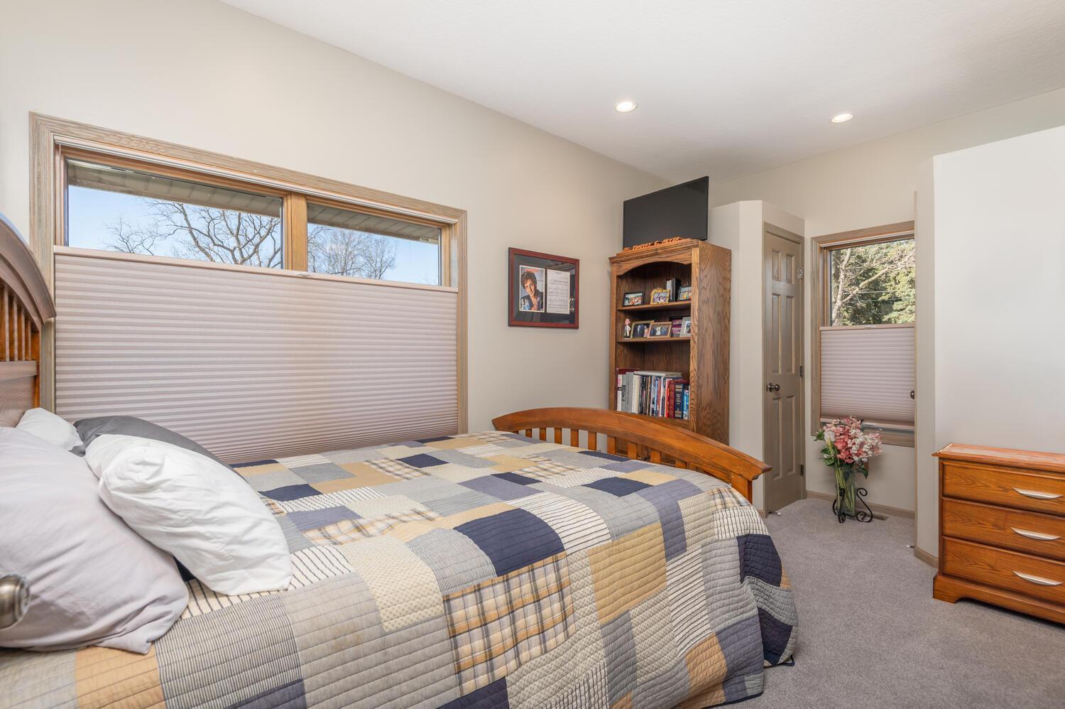 Bedroom two is on the upper level near the primary suite. Throughout the home you will notice all the newer custom blinds!