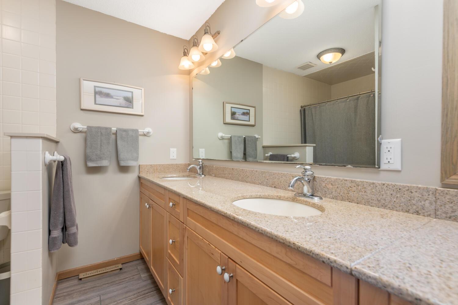 This level also has a roomy remodeled full bath with double vanity and ceramic tile finishes.