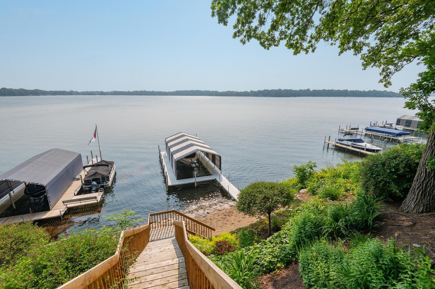 Beautiful landscaping plus sandy beach at lakeside to build a sand castle! Premium boulder shoreline too.