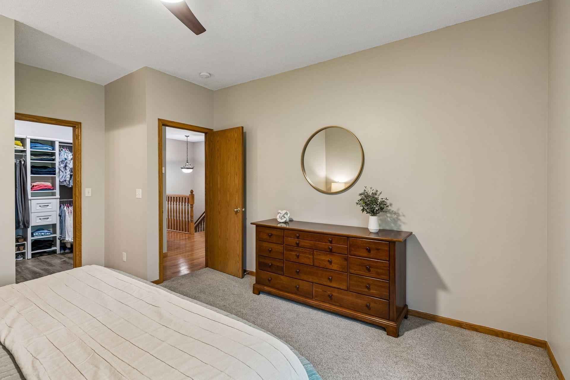 Main-level primary bedroom with private feel, large picture window, and walk-in closet. Comfortable owner’s suite designed for easy living and relaxation.