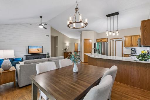 Open-concept main-level layout with vaulted ceilings, hardwood floors, updated kitchen, and spacious dining area. Functional design ideal for everyday living and entertaining guests.