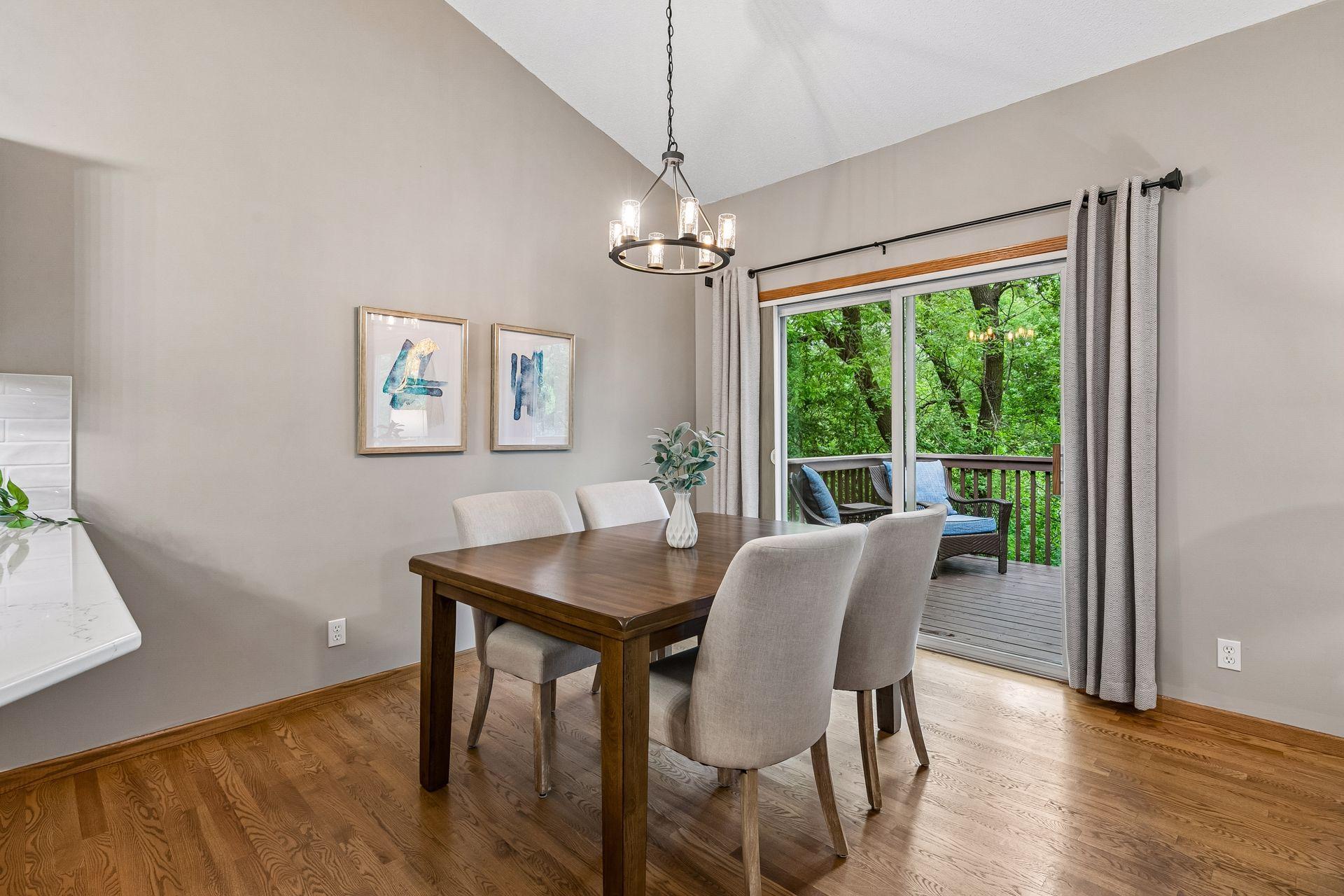 Main-level dining space offers easy access to the deck and backyard scenery. Open layout and large windows create a bright and inviting atmosphere throughout the home.