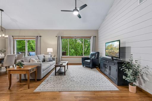 Bright and open main-level living room with vaulted ceilings, large picture windows, hardwood floors and scenic wooded views. Functional layout designed for comfortable everyday living and entertaining.