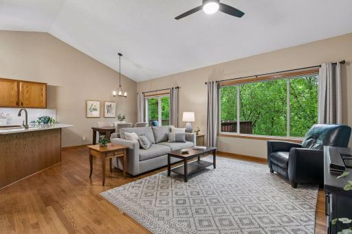 Spacious living and dining area filled with natural light and beautiful backyard views. Main-level layout offers seamless flow between kitchen, dining, deck access and living spaces.