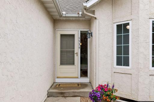 Inviting front entry welcomes you into this well-maintained twin home featuring low-maintenance living, mature landscaping, and a quiet residential setting near parks, shopping and easy Twin Cities access.
