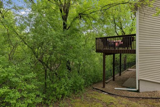 Enjoy peaceful wooded views from the private deck and backyard area, creating a relaxing outdoor setting with added privacy.