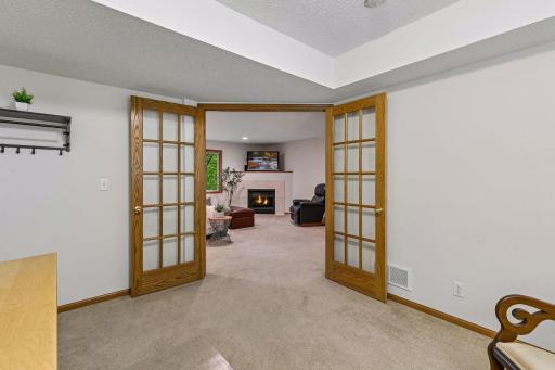 Private office or flex room with French doors opening to the family room, creating a great setup for remote work or guest space.