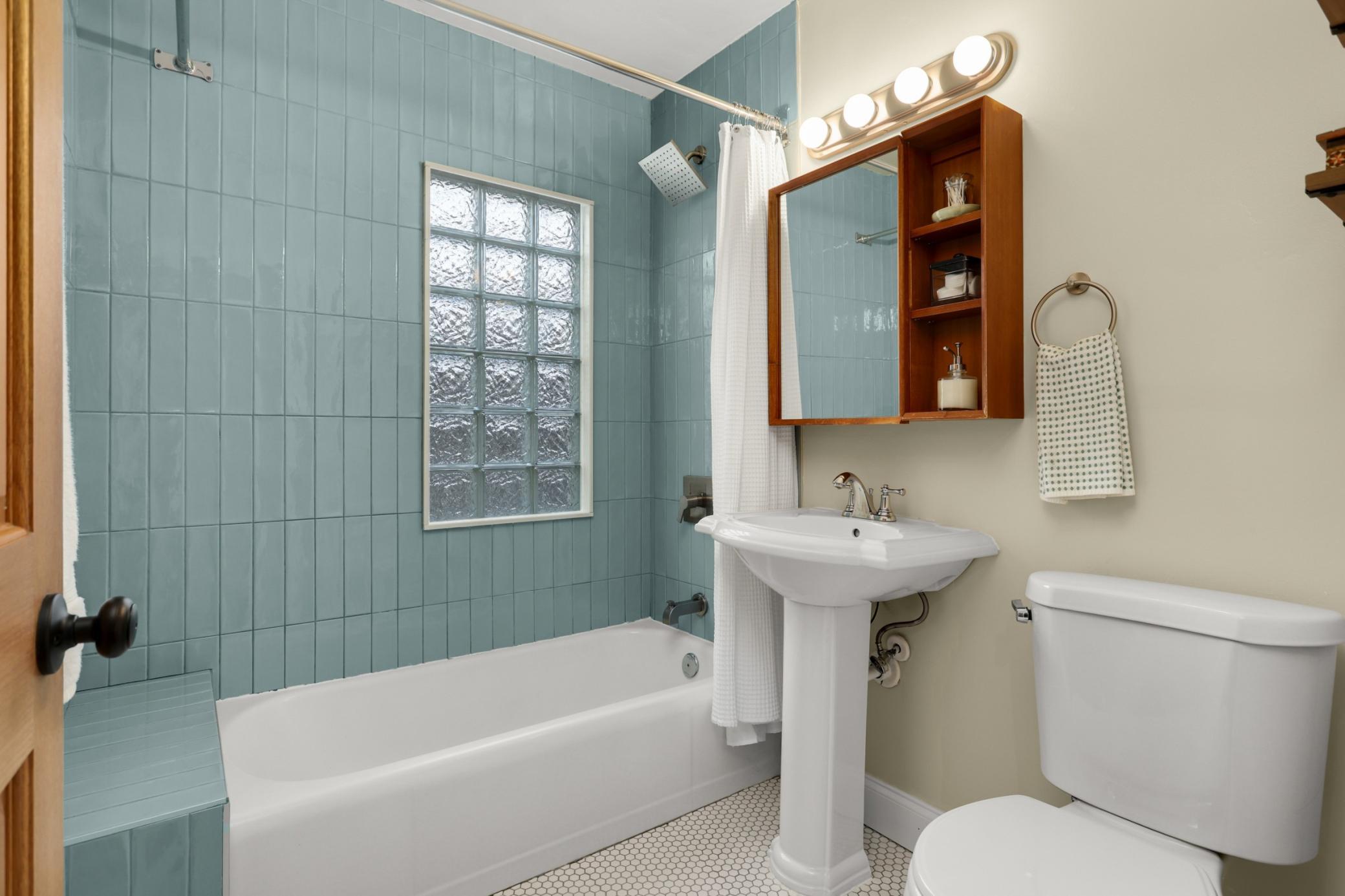 Who doesn't love a fresh bathroom with new vintage inspired tile flooring, combined with tiled shower bench for modern day shaving?
