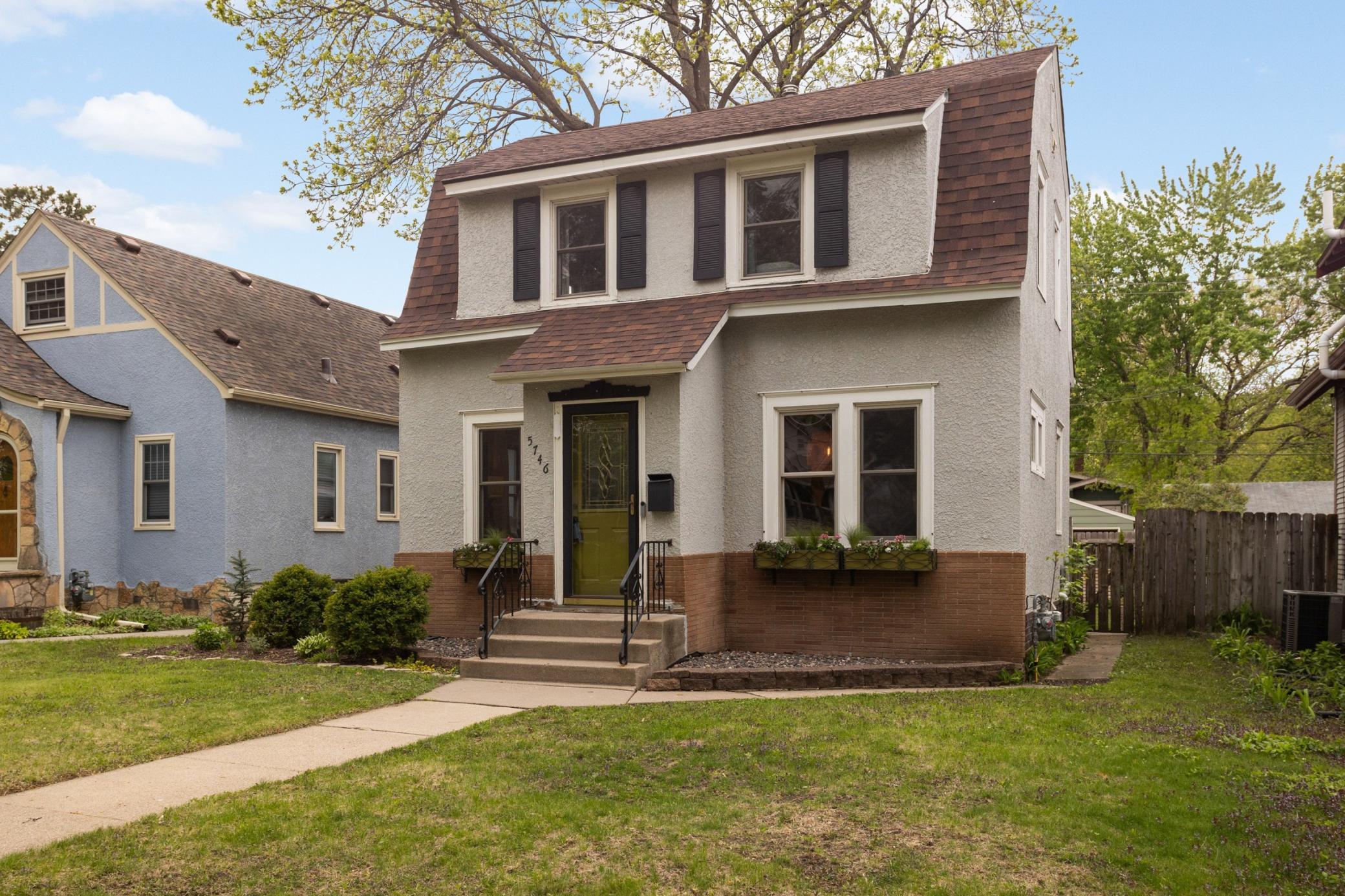 Moody window shutters, flower boxes, and the olive toned front door is giving real life storybook feels that could be yours.