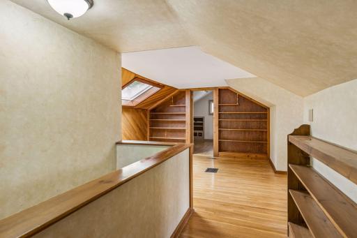 A versatile upper-level sitting roomâideal as an office or libraryâsunny and bright by a south-facing skylight.