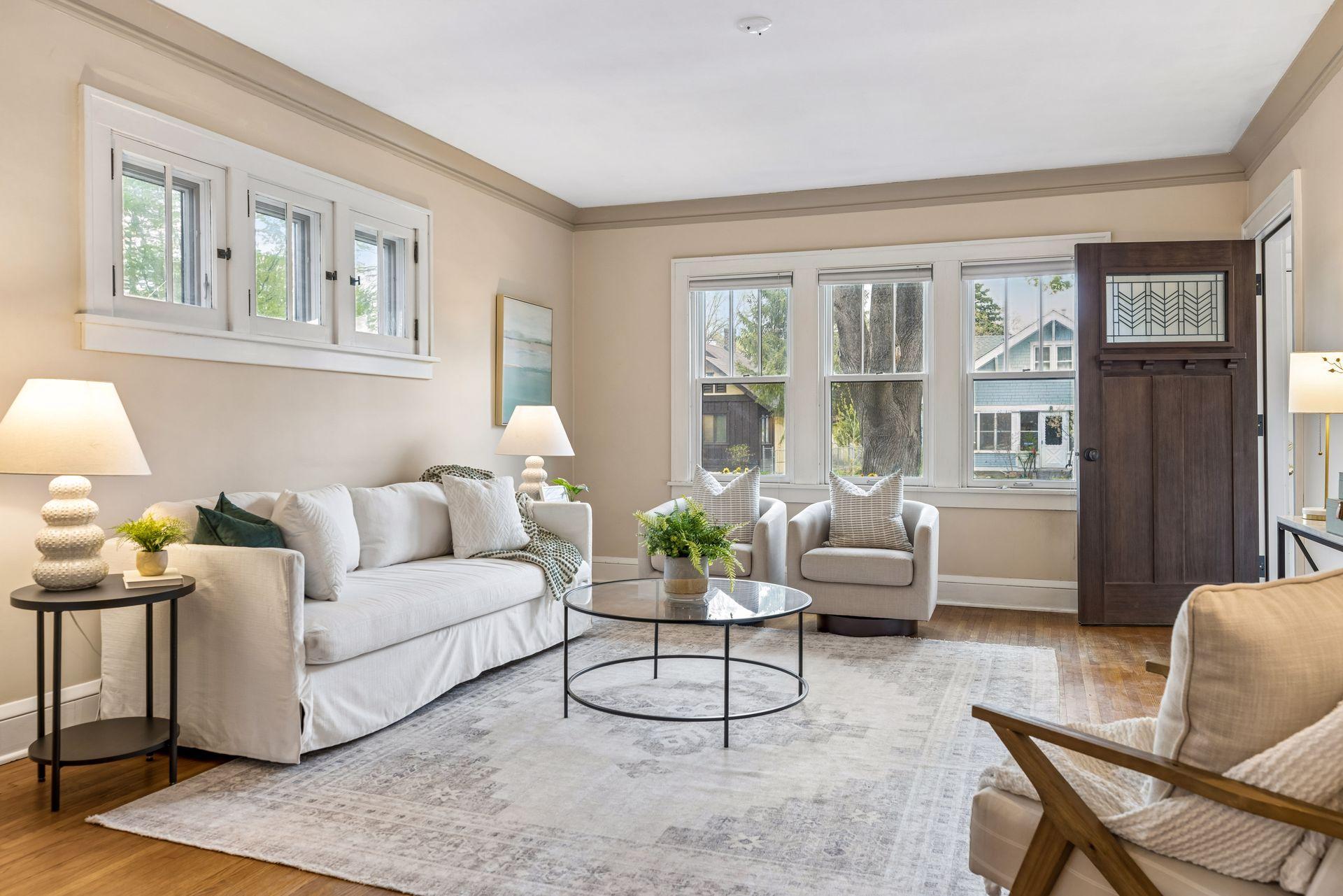 The spacious formal living room is filled with natural light from large west-facing windows.