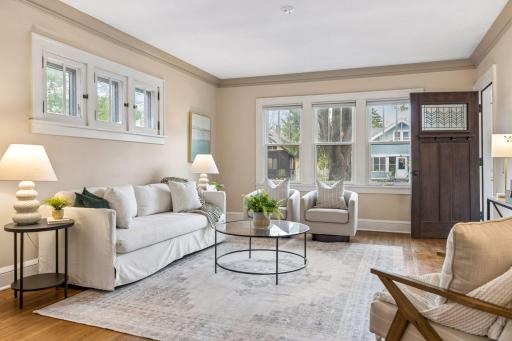 The spacious formal living room is filled with natural light from large west-facing windows.