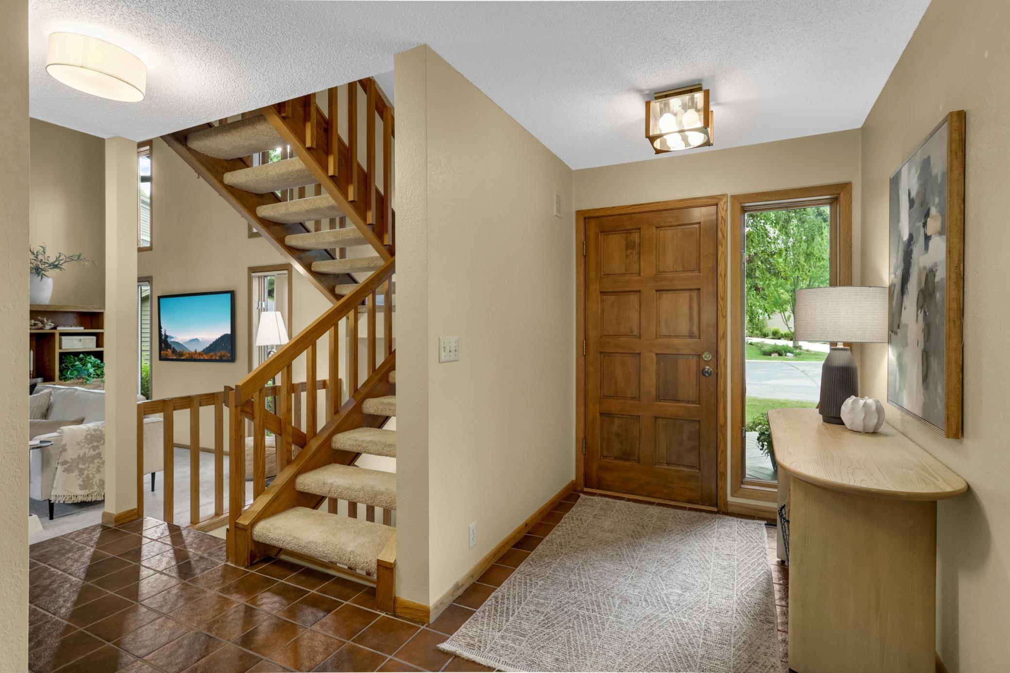 A warm and welcoming entry showcases the home’s beautiful natural woodwork and open, light-filled design.