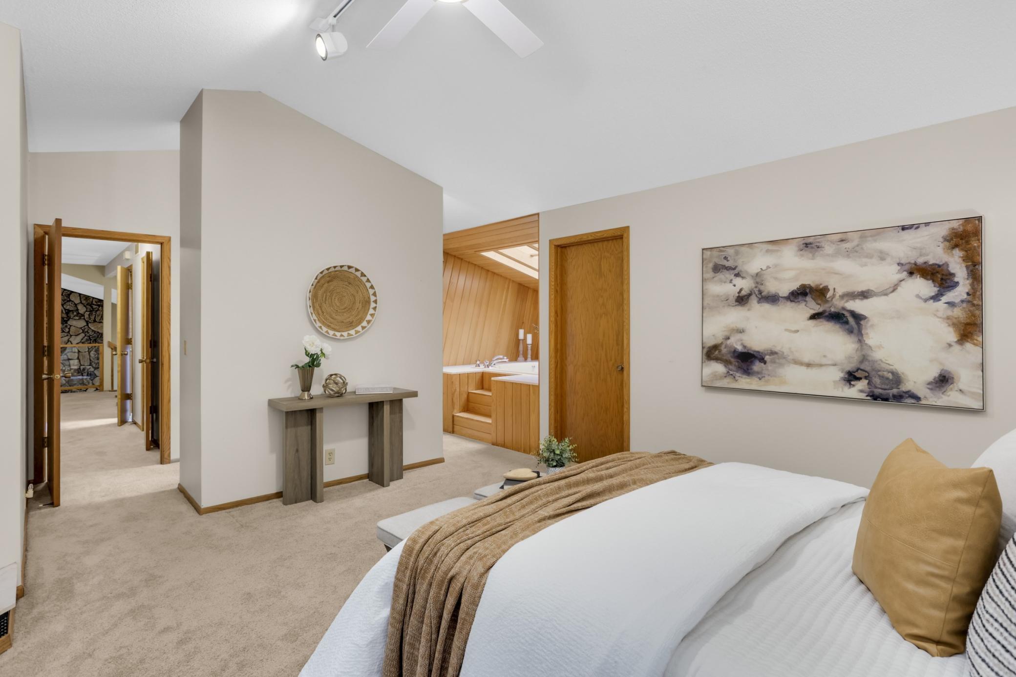 Another view from the primary bedroom, walk-in closet and soaking tub.