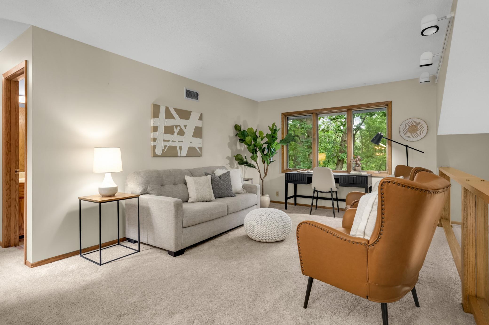 The spacious upper-level loft overlooks the living room and offers a versatile space for a home office, reading nook or additional lounge area.