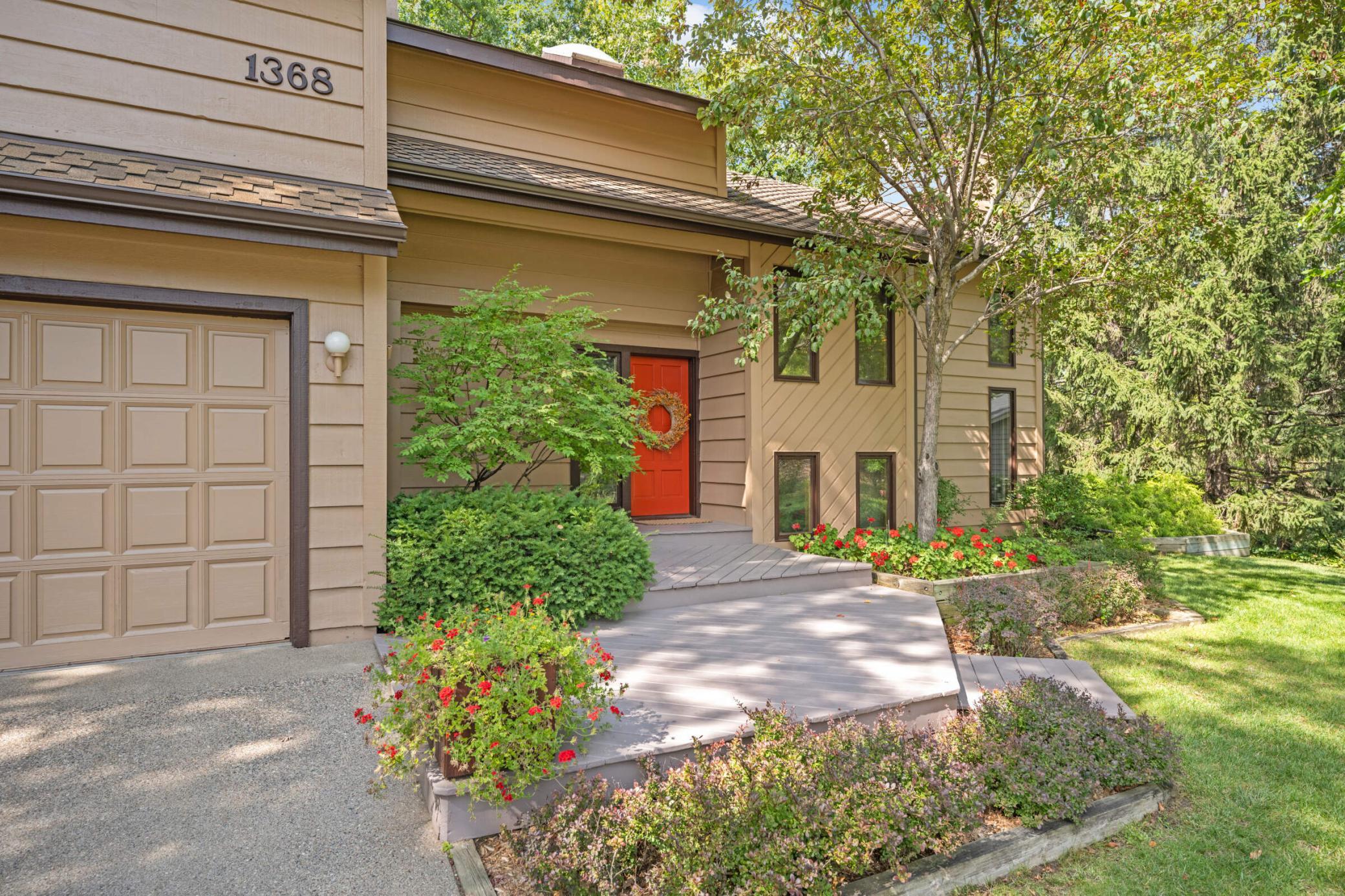 Additional photos from 2022 showcasing the home’s beautifully maintained lawn, mature trees and lush landscaping in full bloom.