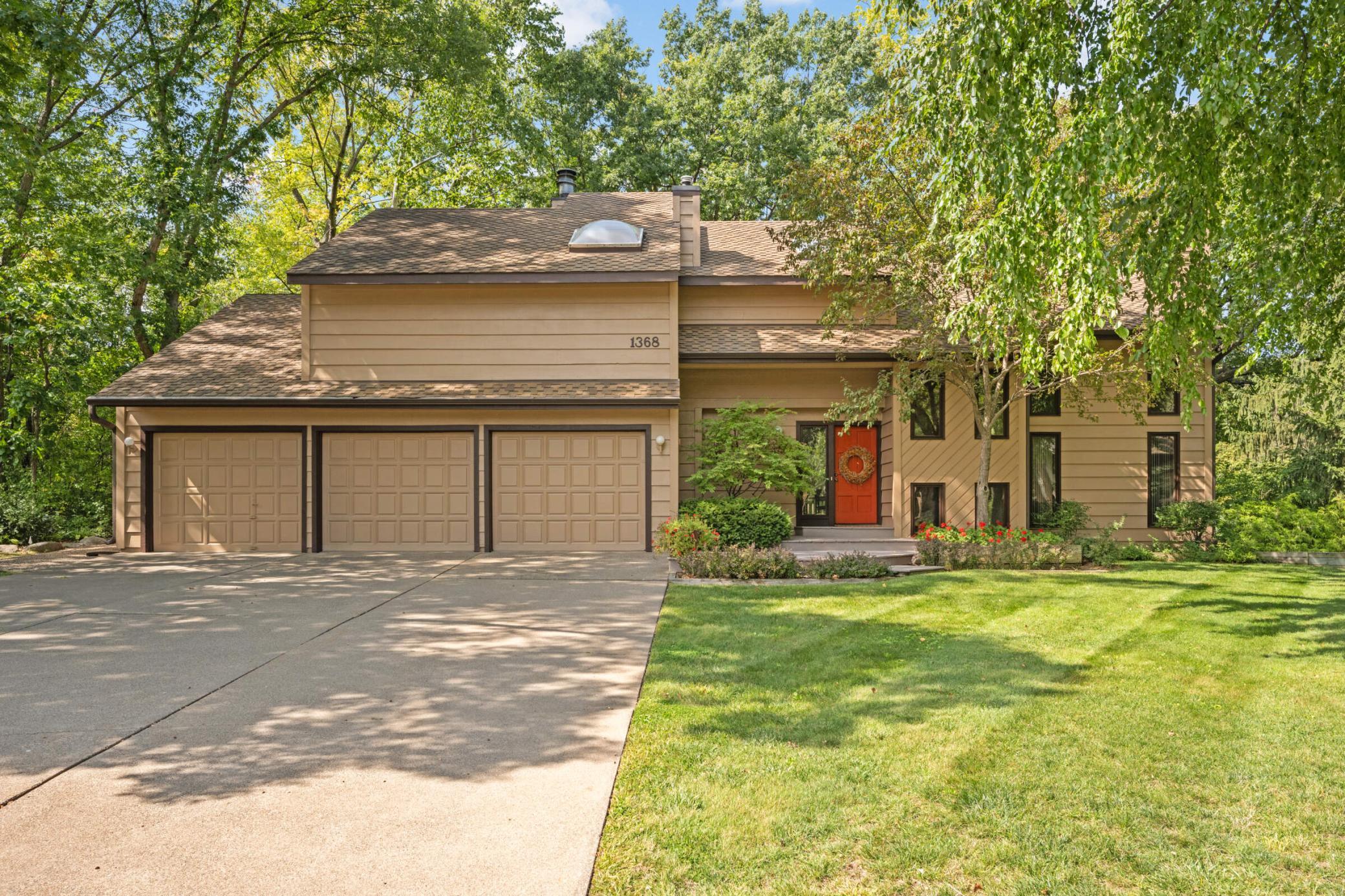 Additional photos from 2022 showcasing the home’s beautifully maintained lawn, mature trees and lush landscaping in full bloom.