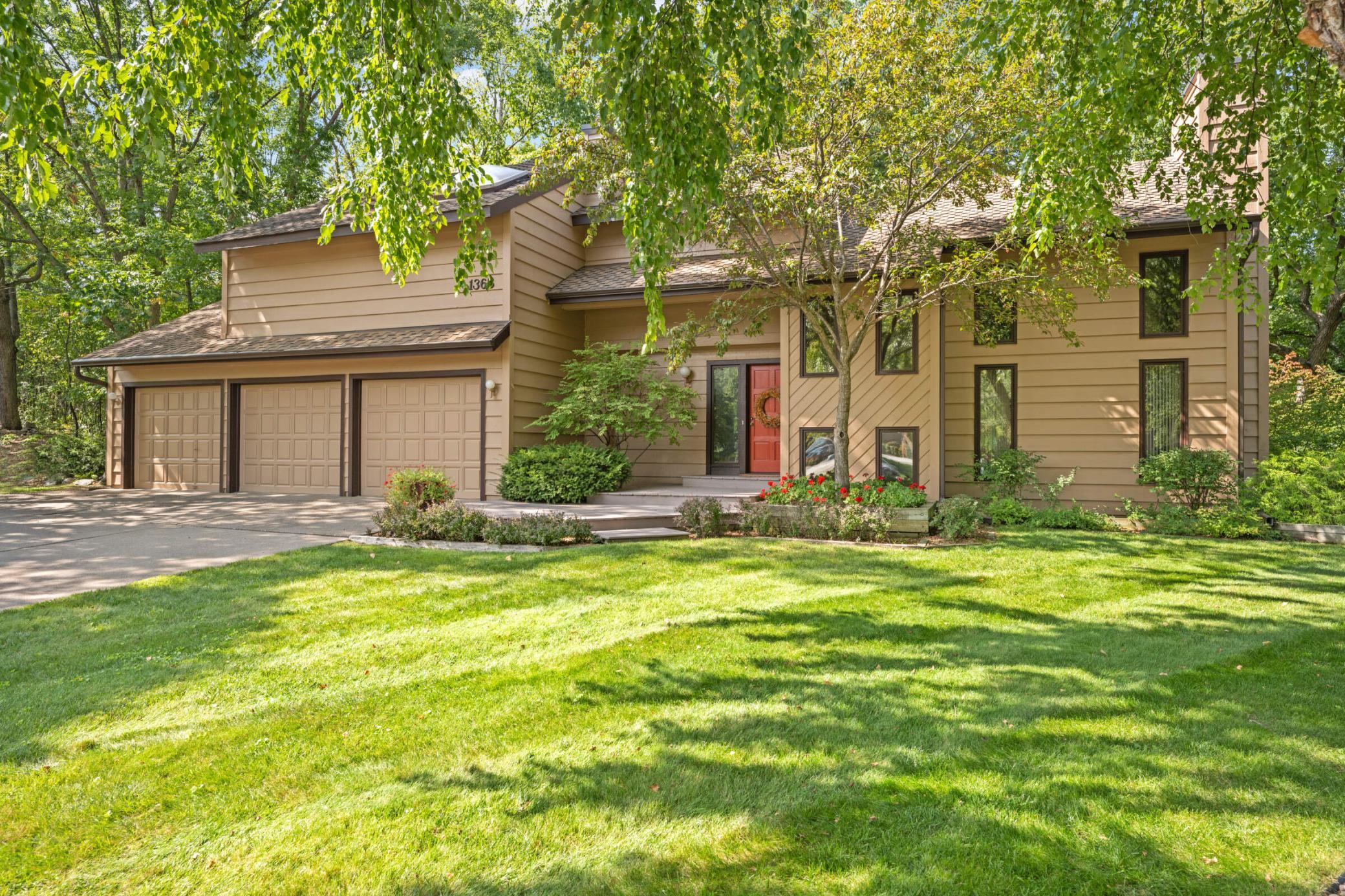 Additional photos from 2022 showcasing the home’s beautifully maintained lawn, mature trees and lush landscaping in full bloom.
