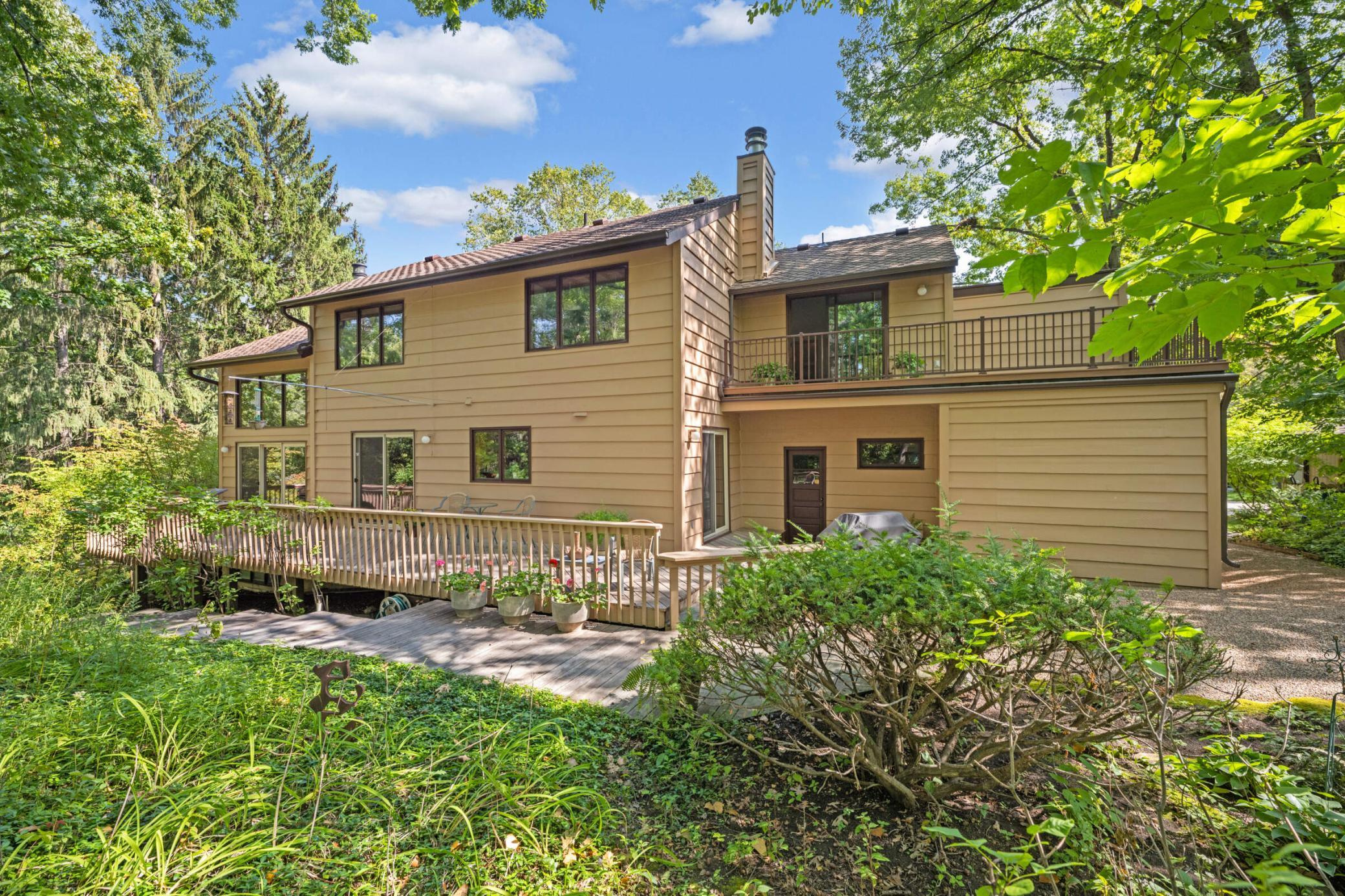 Additional photos from 2022 showcasing the home’s beautifully maintained lawn, mature trees and lush landscaping in full bloom.