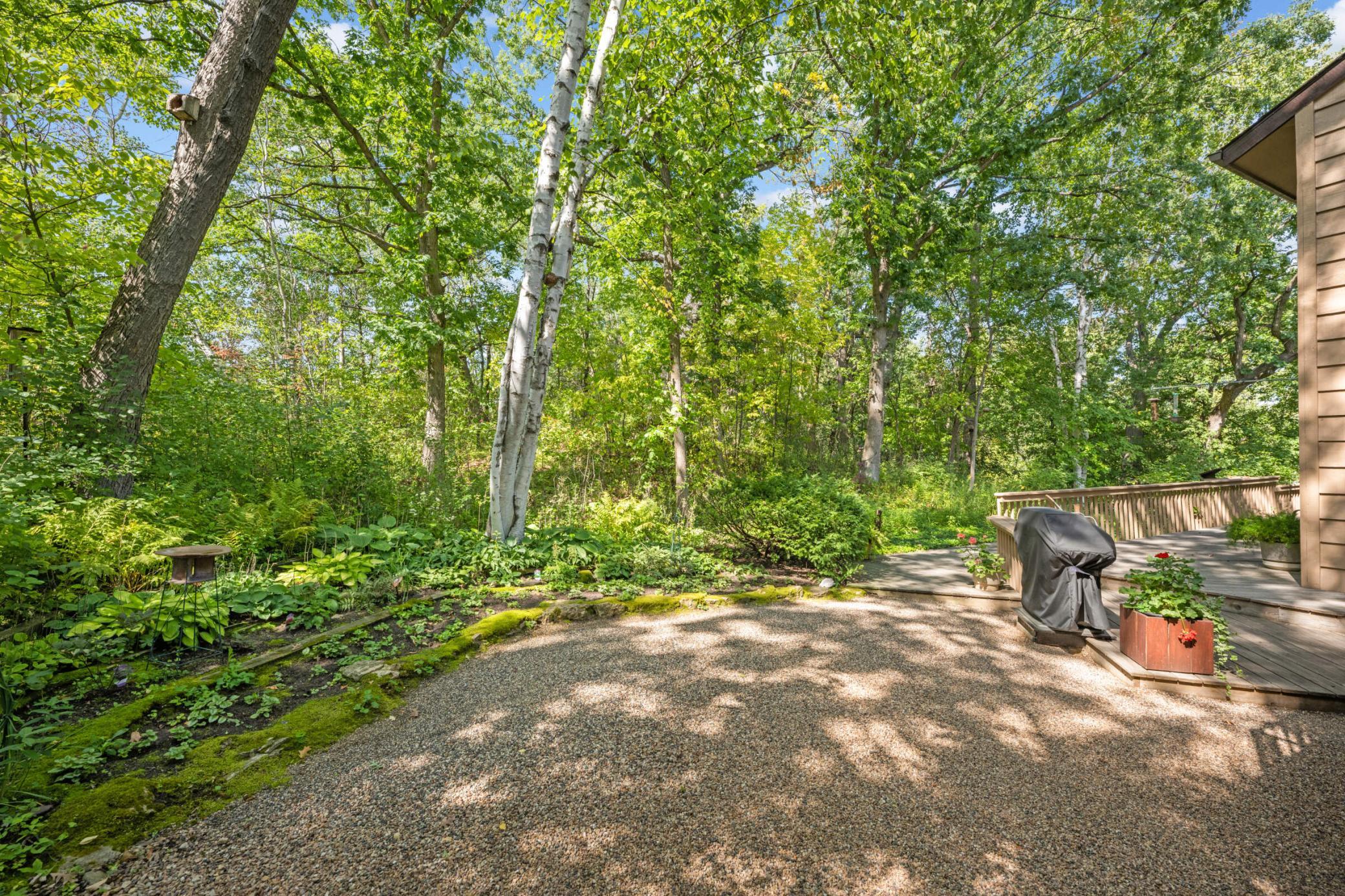 Additional photos from 2022 showcasing the home’s beautifully maintained lawn, mature trees and lush landscaping in full bloom.